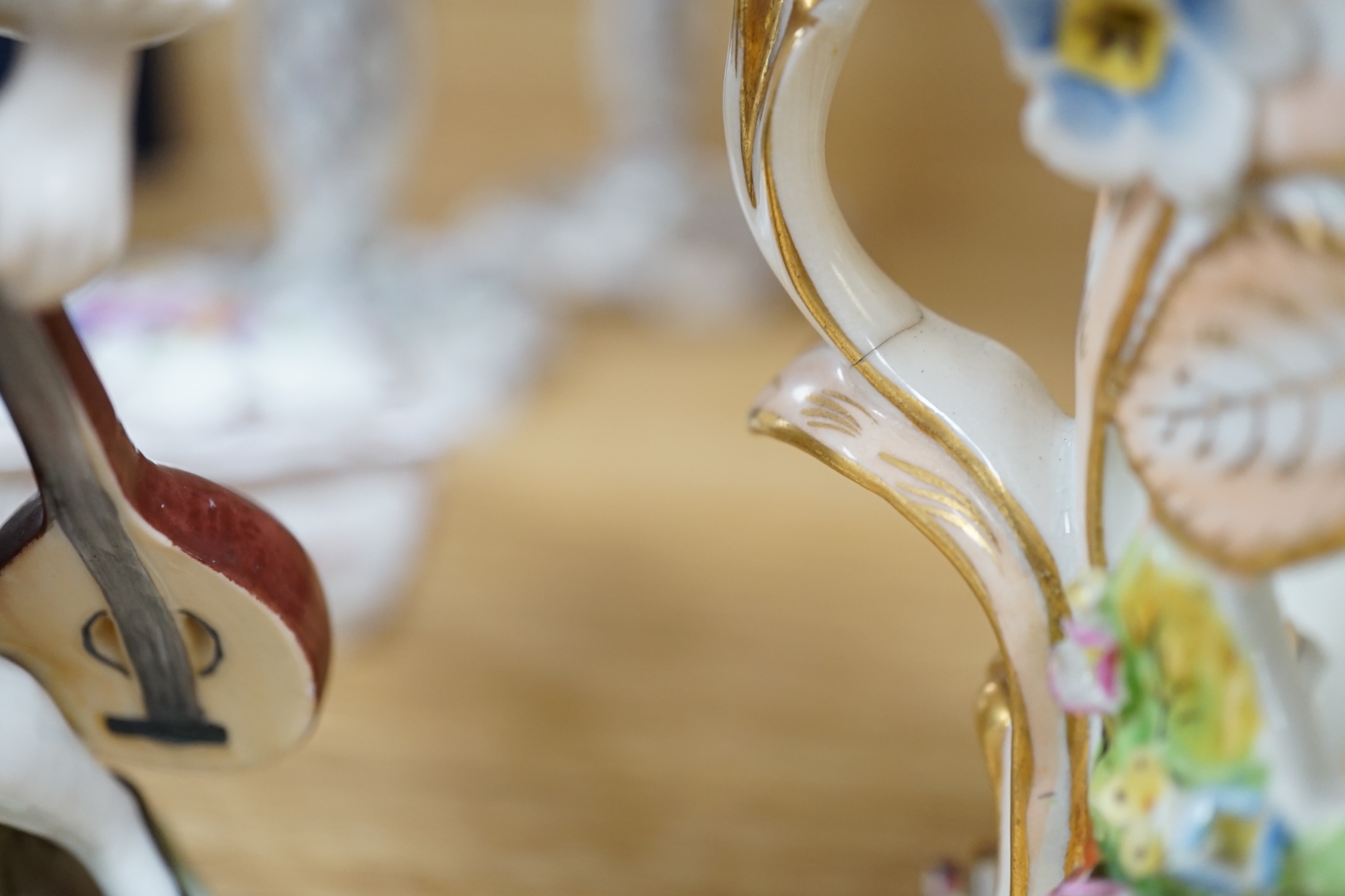 A porcelain shell-shaped centrepiece, a Dresden pill box, a pair of taper holders and a porcelain figure, tallest 21cm